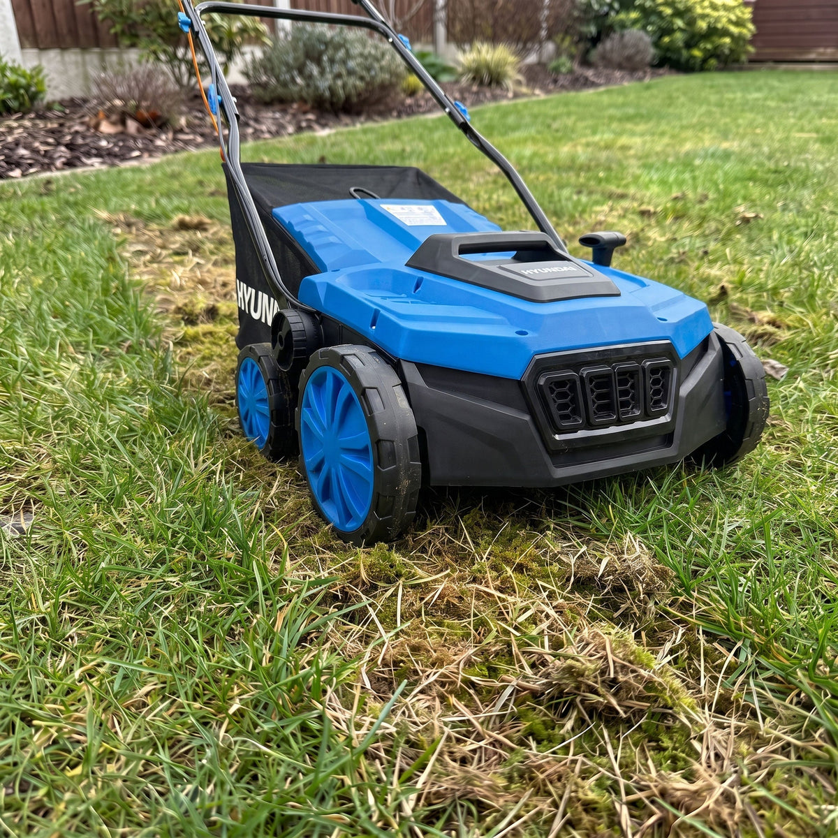 Hyundai HYSC1600E making one light scarifying pass on a dry, actively growing UK lawn